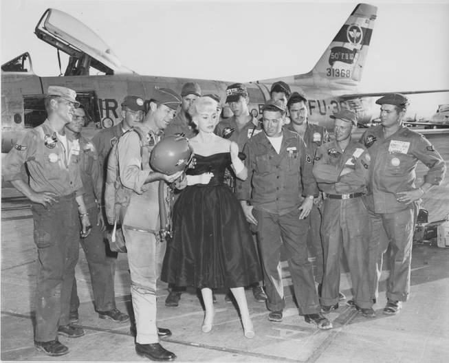 Commander Chuck Yeager and Zsa Zsa Gabor visit Nellis Air Force Base.  Yeager's F-86 is the backdrop, circa 1957.  
